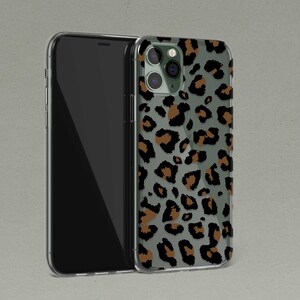 May include: A clear phone case with a brown and black leopard print design. The case is designed for an iPhone.