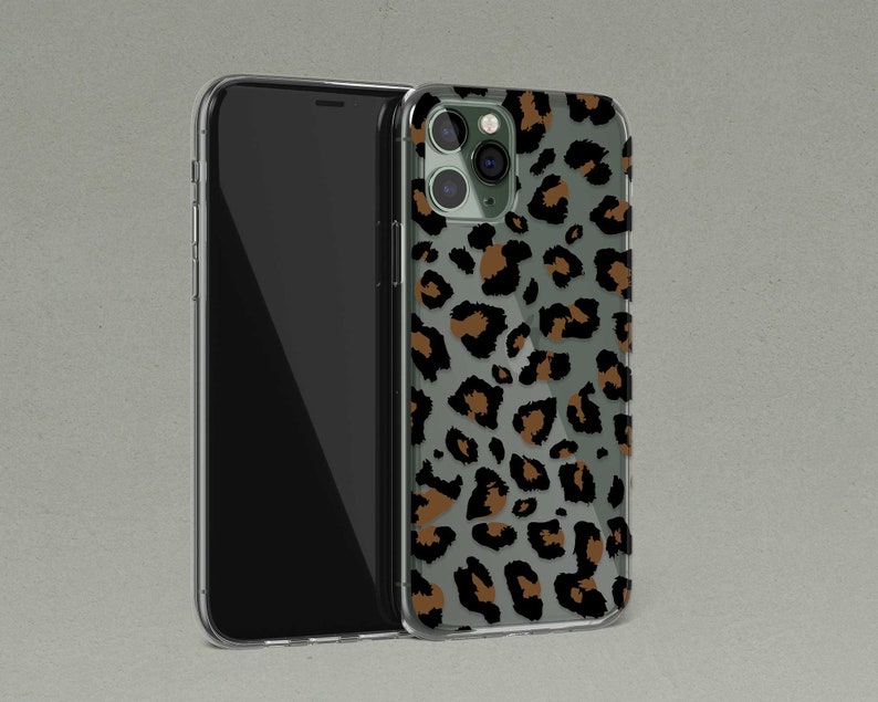 May include: A clear phone case with a brown and black leopard print design. The case is designed for an iPhone.