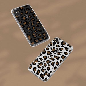 May include: Two clear phone cases with a leopard print design. One case has a black background with brown spots, and the other case has a white background with brown spots.
