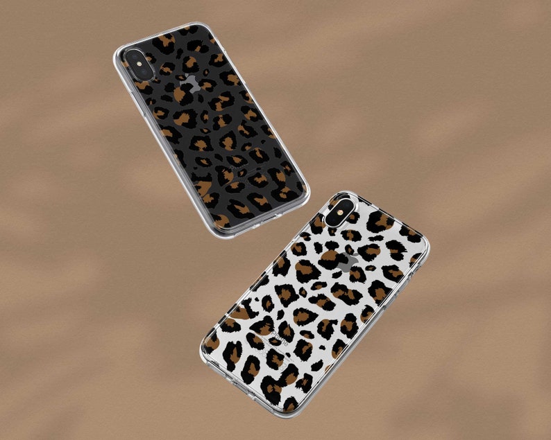 May include: Two clear phone cases with a leopard print design. One case has a black background with brown spots, and the other case has a white background with brown spots.
