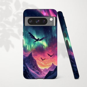 May include: A phone case featuring a fantasy landscape with dragons flying under a colorful aurora borealis. The case is dark blue with a mountain range at the bottom and a vibrant sky with shades of pink, purple, and green.