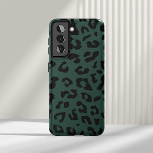 May include: A green phone case with a black leopard print design.