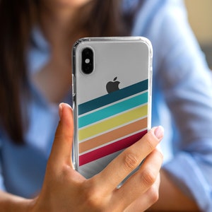 May include: A clear phone case with a colorful striped design and an Apple logo. The case has a dark blue, turquoise, yellow, orange, and red stripe pattern.