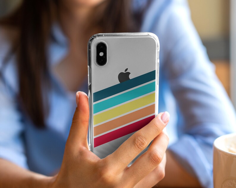 May include: A clear phone case with a colorful striped design and an Apple logo. The case has a dark blue, turquoise, yellow, orange, and red stripe pattern.