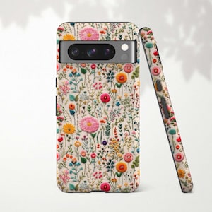 May include: A phone case and matching phone cover featuring a floral pattern with pink, yellow, and orange flowers on a cream background. The case has a camera cutout and a sleek design.