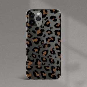 May include: A clear phone case with a brown and black leopard print design.