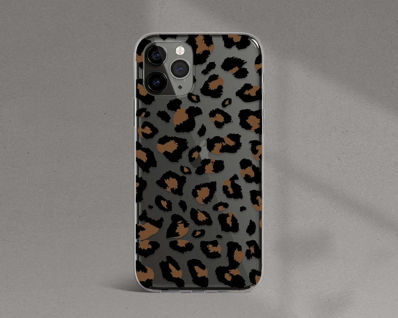 May include: A clear phone case with a brown and black leopard print design.