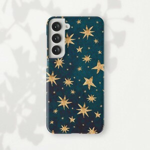 a phone case with gold stars on a green background