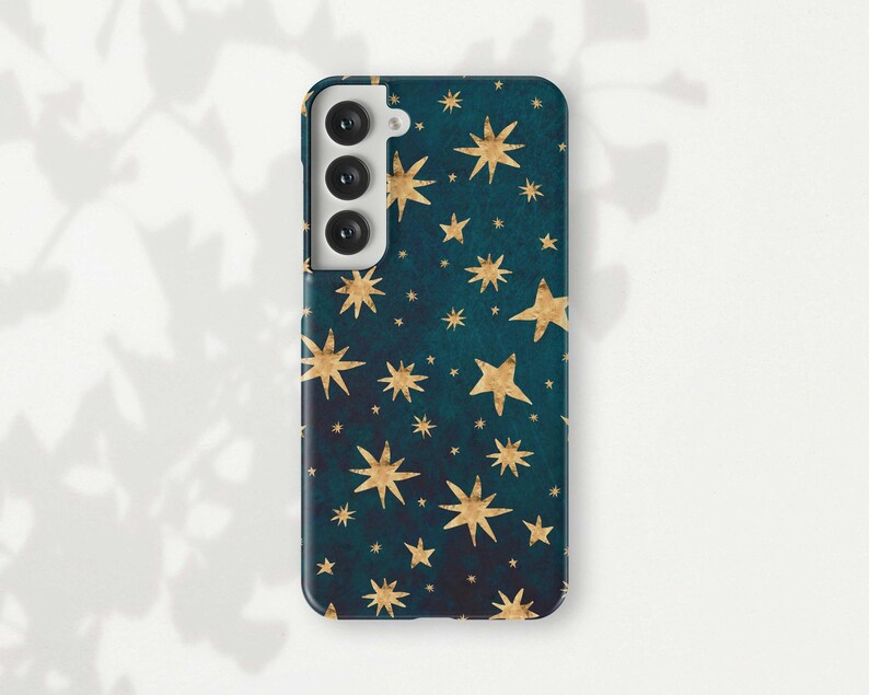 a phone case with gold stars on a green background