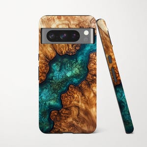May include: A wooden phone case with a teal and brown resin design. The case has a camera cutout and a matching side piece. The wood grain pattern is visible, and the resin creates a river-like effect. The case is designed for a smartphone.