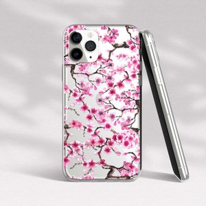 Puede incluir: Una funda transparente para tel&eacute;fono con un dise&ntilde;o de flores de cerezo rosa y blanco. La funda est&aacute; dise&ntilde;ada para un iPhone.