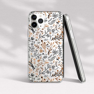 May include: A clear phone case with a floral pattern in black, brown, and white. The case is designed for an iPhone with a camera bump.