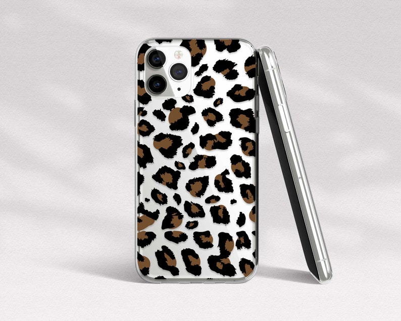 May include: A clear phone case with a brown and white leopard print design. The case is designed for an iPhone.