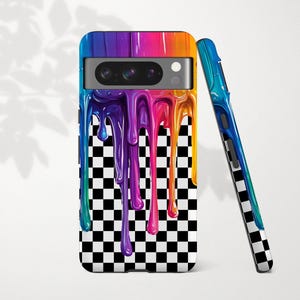 May include: A colorful phone case with a vibrant design. The case features a rainbow-colored top that drips down over a black and white checkered pattern. A second case is leaning against the first, showing the same design.