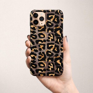 a person holding a cell phone in their hand