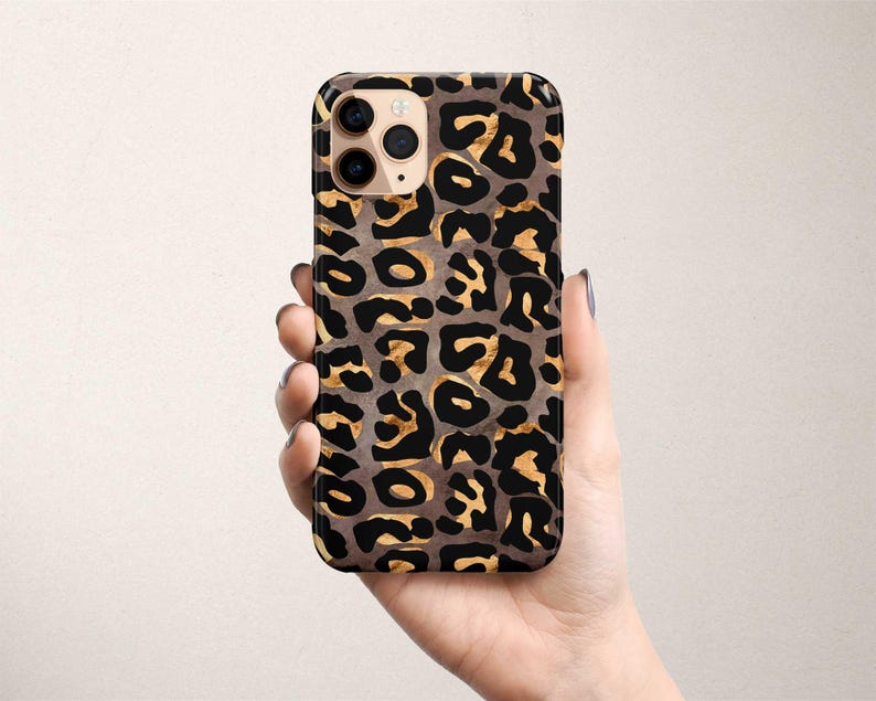 a person holding a cell phone in their hand