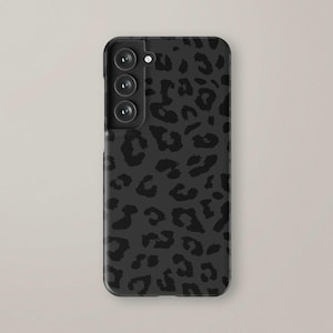 May include: Black phone case with a leopard print design.