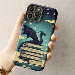 May include: A black dragon silhouette perched atop a stack of books against a blue and green starry night sky. The phone case features a whimsical design with clouds and stars.