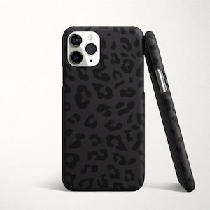 May include: Black phone case with a leopard print design. The case has a raised camera bump and a cutout for the phone's buttons.