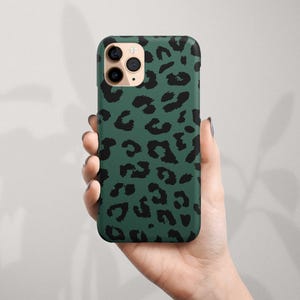May include: A green phone case with a black leopard print design.