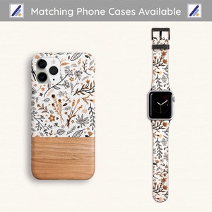 May include: A white phone case with a floral pattern and a wood-grain bottom. A matching floral watch band is also shown.