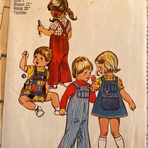 May include: A vintage Simplicity sewing pattern for children's overalls. The pattern shows three children wearing different styles of overalls: one in red, one in blue and white stripes, and one in blue denim. The pattern is for size 2, with a 21 inch breast and 20 inch waist.