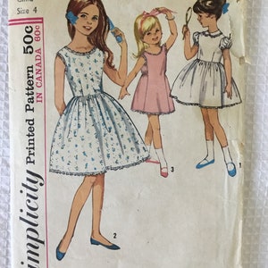 May include: Vintage Simplicity printed pattern for a child's dress, size 4. The cover features illustrations of three young girls in dresses. The pattern includes the text "Printed Pattern 50c" and "IN CANADA 60c".