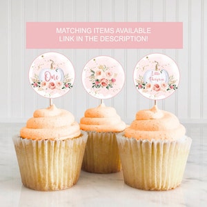 May include: Three cupcake toppers with pink and gold pumpkin designs. The toppers say "One", "Little Pumpkin", and feature a floral design.