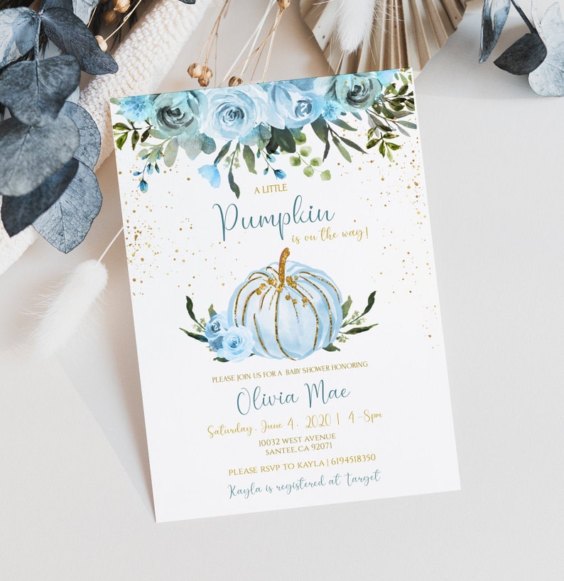 May include: Baby shower invitation with a blue watercolor pumpkin and floral design. The invitation includes the text "A Little Pumpkin is on the way!" and event details in gold and blue. The invitation is for Olivia Mae.