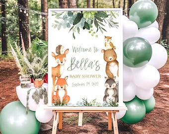 May include: A white sign with a green leafy border and woodland animals. The sign says "Welcome to Bella's Baby Shower, September 24, 2023".