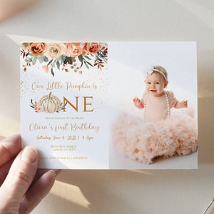May include: A fall-themed first birthday invitation with a pumpkin and the word "ONE" in gold lettering. The invitation features a photo of a baby girl wearing a pink tutu and a white headband. The text on the invitation reads "Our Little Pumpkin is ONE. Please join us to celebrate Olivia's first birthday. Saturday, June 4, 2020 | 4-8pm. 10012 West Avenue, Santee, CA 92021. Please RSVP to Kayla | (619) 451-8350."