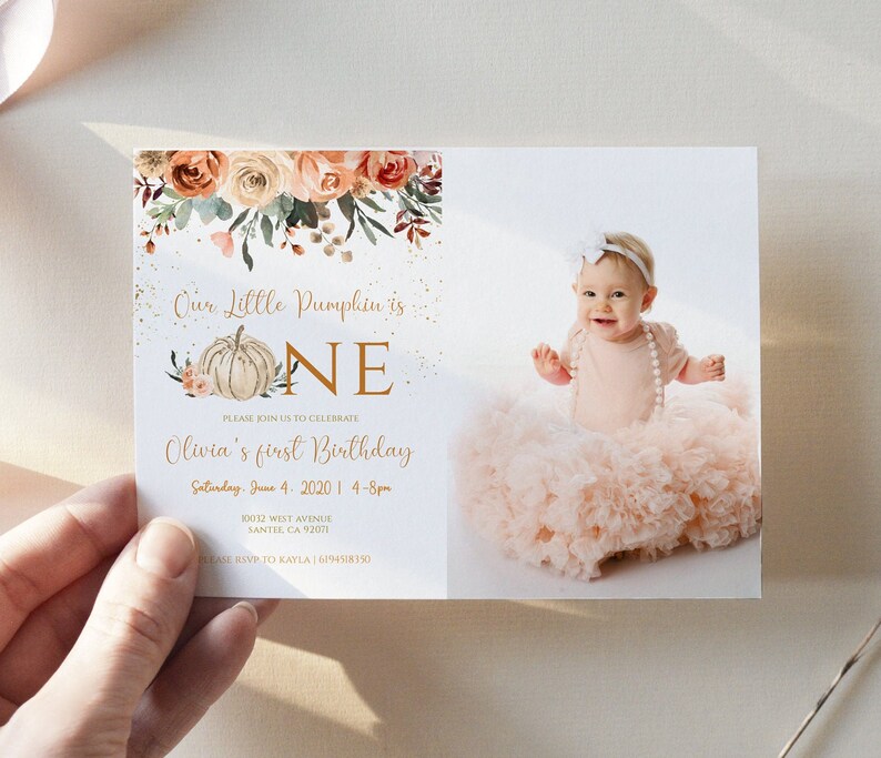 May include: A fall-themed first birthday invitation with a pumpkin and the word "ONE" in gold lettering. The invitation features a photo of a baby girl wearing a pink tutu and a white headband. The text on the invitation reads "Our Little Pumpkin is ONE. Please join us to celebrate Olivia's first birthday. Saturday, June 4, 2020 | 4-8pm. 10012 West Avenue, Santee, CA 92021. Please RSVP to Kayla | (619) 451-8350."