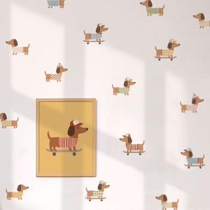 May include: A wall decal set featuring multiple brown dachshunds in various outfits, including sweaters and caps, some riding skateboards. A framed yellow print displays a single dachshund wearing a red striped sweater and cap on a skateboard.