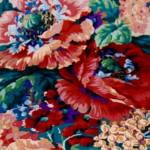 May include: A floral fabric with a repeating pattern of large red, pink, and white flowers with green leaves. The background is a light beige color.