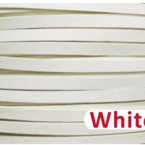 May include: White leather cord, rolled up in a coil. The cord is approximately 3mm wide.