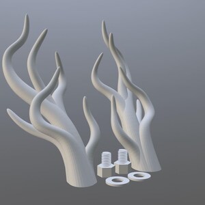 Peut inclure: Deux sculptures blanches abstraites en forme de cornes, avec des formes courbes et allong&eacute;es. L'image pr&eacute;sente &eacute;galement deux boulons et deux rondelles. Les objets sont pos&eacute;s sur un fond gris.
