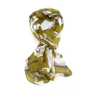 May include: A green scarf with a white crane print. The scarf is made of a lightweight fabric and is perfect for adding a touch of style to any outfit.