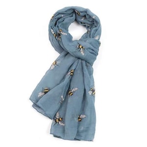 May include: A blue scarf featuring a pattern of yellow and black bees. The scarf is made from a soft, lightweight fabric and is ideal for adding a touch of whimsy to any outfit.