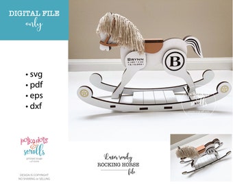 May include: A white wooden rocking horse with a tan saddle and a mane of light-colored yarn. The horse has a large letter "B" on its side and the name "Brynn" with birth details. The text "Laser ready ROCKING HORSE file" is also present.