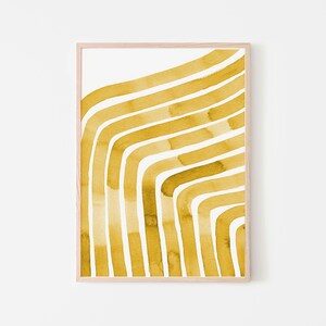May include: A framed print with a yellow abstract design of curved lines. The lines are painted in a watercolor style and create a modern and minimalist look.