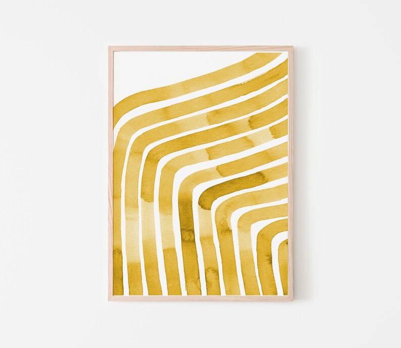 May include: A framed print with a yellow abstract design of curved lines. The lines are painted in a watercolor style and create a modern and minimalist look.