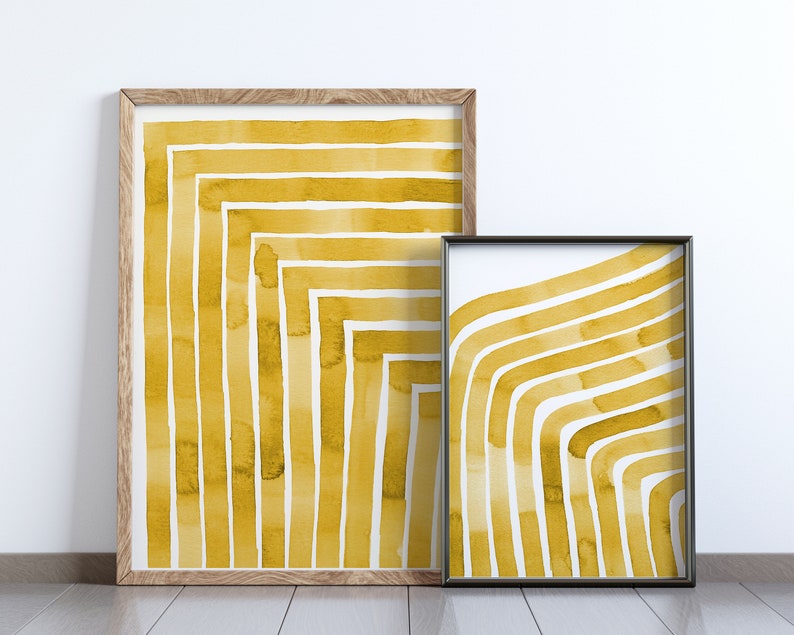 May include: Two framed abstract watercolor prints with a yellow and white striped pattern. The prints are in different sizes and have a modern minimalist style.