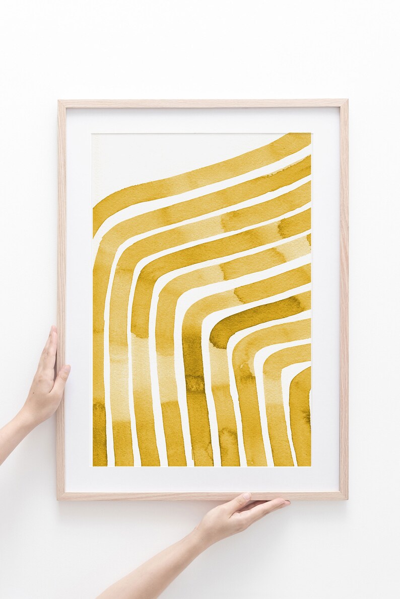 May include: A framed print with a watercolor design of abstract yellow lines on a white background.