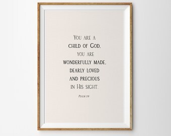 May include: A framed print with a beige background and black text that reads "You are a child of God, you are wonderfully made, dearly loved and precious in His sight. Psalm 139."
