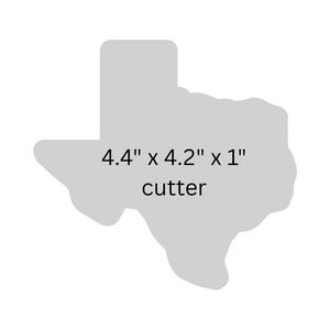 Könnte beinhalten: Ein grauer Ausstecher in Texas-Form, 11,2 cm x 10,7 cm x 2,5 cm groß. Der Ausstecher ist ein schlichtes Design, ideal für Bastel- oder Backprojekte. Der Text "cutter" steht unter den Maßen.