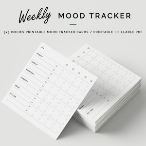 May include: A stack of white 3x3 inch printable mood tracker cards. The cards have a minimalist design with lines for each day of the week and spaces for tracking mood. The text "Weekly MOOD TRACKER" is at the top.