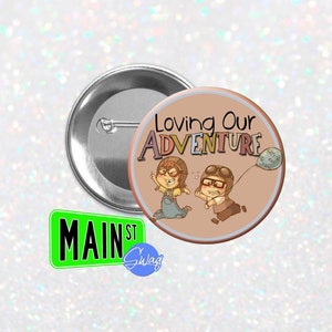 May include: A brown button with a cartoon image of two people holding a balloon that says "Sprite & Ice Cream". The text "Loving Our Adventure" is written in large letters above the cartoon image.