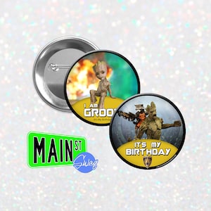 May include: Two round button badges featuring the character Groot from the Guardians of the Galaxy film franchise. The first badge shows Groot standing on a yellow platform with a fiery background and the text "I am Groot It's My Birthday". The second badge shows Groot and Rocket Raccoon standing on a yellow platform with a futuristic city background and the text "It's My Birthday".