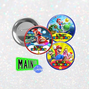 May include: Four round, colorful, printed buttons with the text "It's My Birthday" and images of Mario Kart characters. The buttons are for a birthday party.