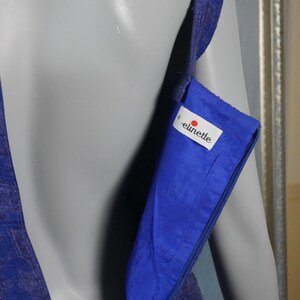 May include: A royal blue sleeveless dress with a zipper closure and a label that reads "elinette" on the inside.